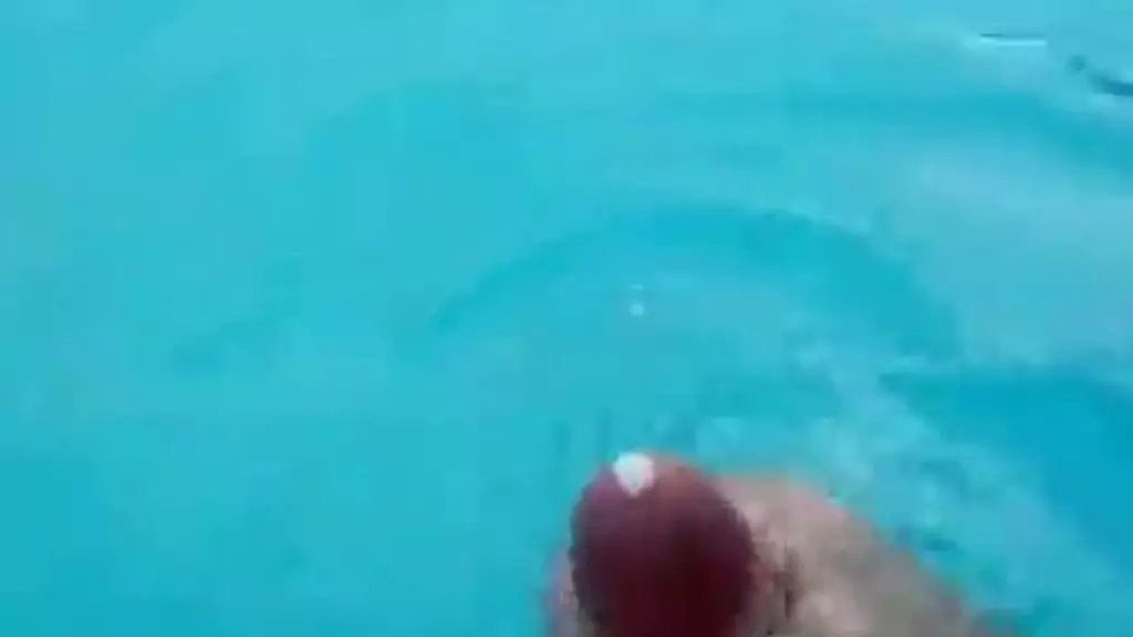 boy enjoys his time in the pool as he masturbates and cums