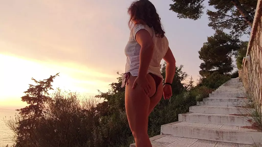 girl is pissing on hill during sunset!